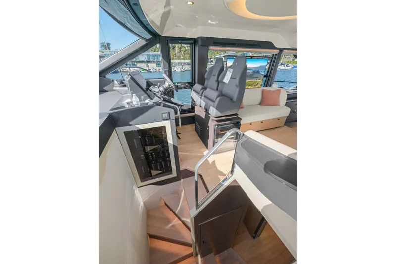 Slide: The Image of Interior of 2026 Absolute 52 Fly yacht, featuring modern helm and seating area. - 37