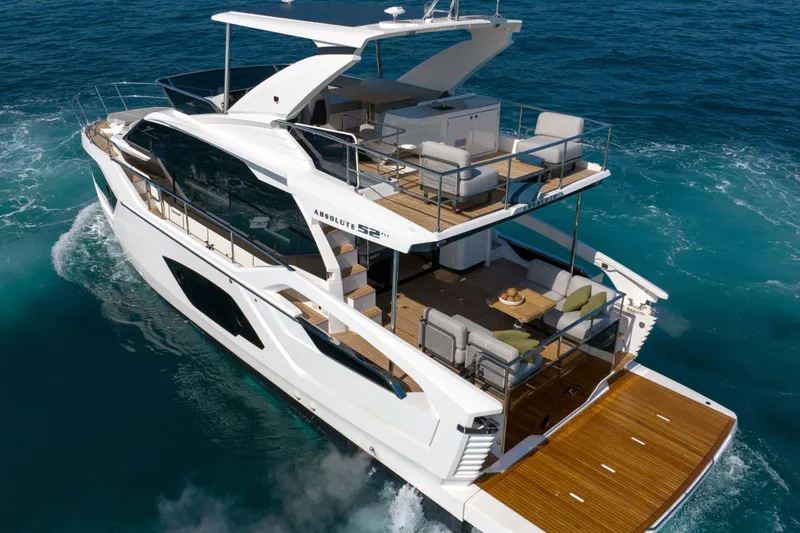 Slide: The Image of Luxurious 2026 Absolute 52 Fly yacht cruising on clear blue waters. - 8