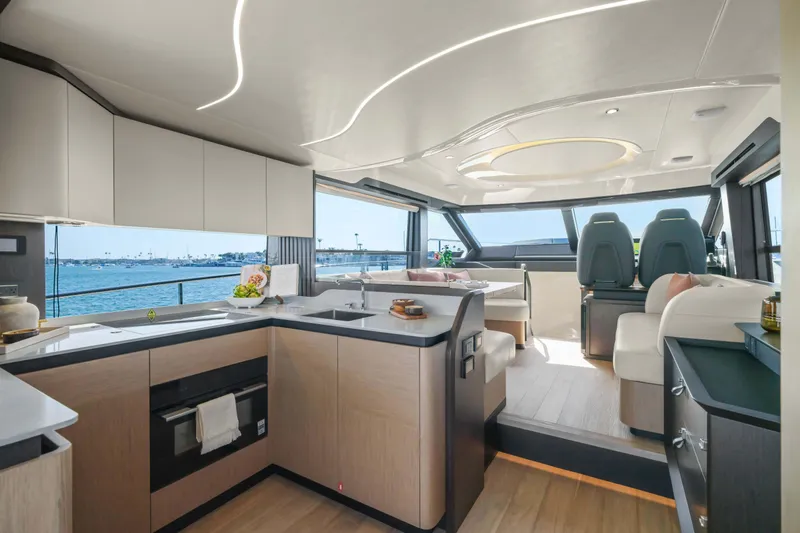 Slide: The Image of Luxurious interior of 2026 Absolute 52 Fly yacht with modern kitchen and seating area. - 25