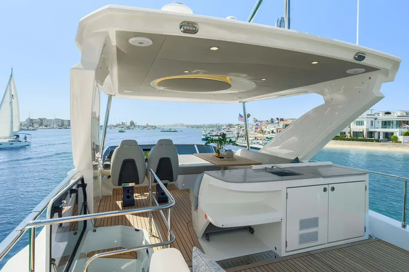 Slide: The Image of Luxurious 2026 Absolute 52 Fly yacht with spacious deck and modern amenities, cruising on serene waters. - 16