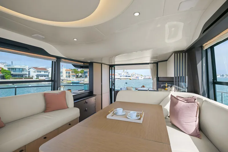 Slide: The Image of Luxurious interior of 2026 Absolute 52 Fly yacht with elegant seating and waterfront view. - 22