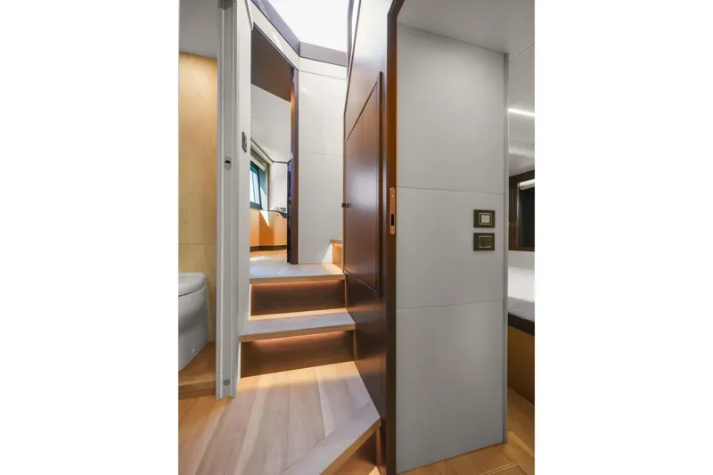 Slide: The Image of Interior staircase of 2026 Absolute 52 Fly yacht, featuring modern design and ambient lighting. - 50