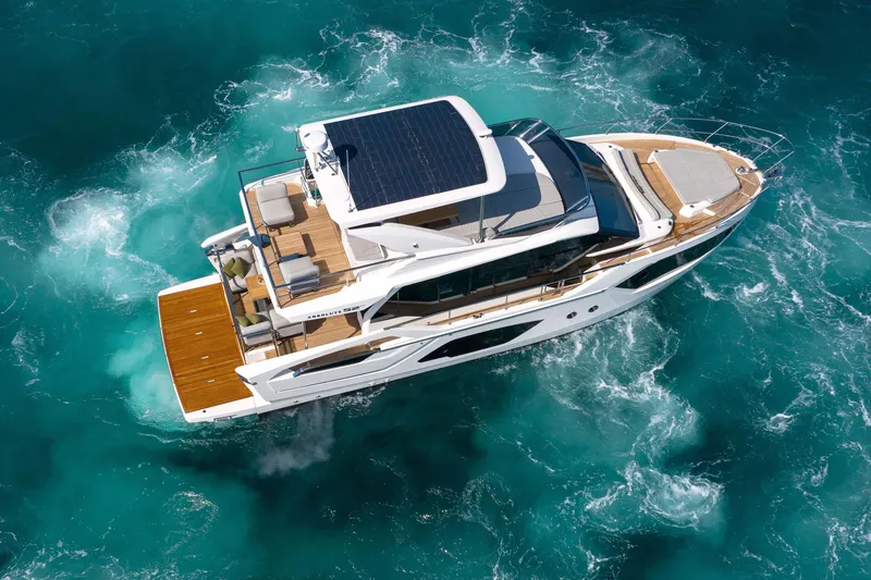 Slide: The Image of Aerial view of 2026 Absolute 52 Fly yacht cruising in turquoise waters. - 11