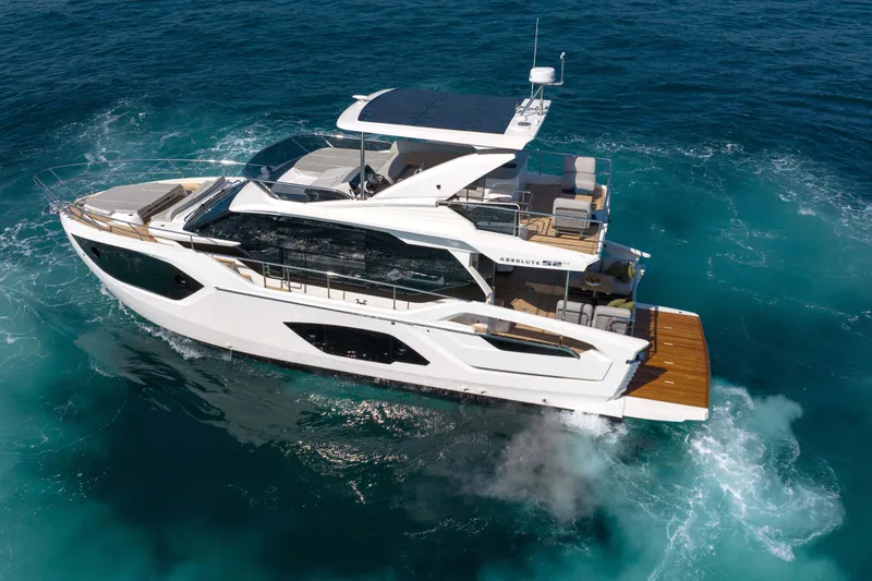 Slide: The Image of Luxurious 2026 Absolute 52 Fly yacht cruising on clear blue ocean waters. - 9