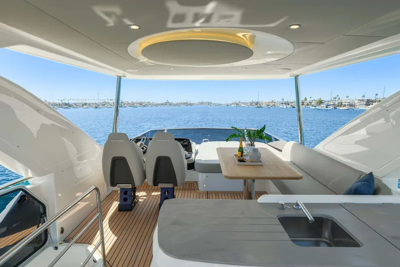 Slide: The Image of Luxurious 2026 Absolute 52 Fly yacht interior with ocean view, featuring seating and dining area. - 14