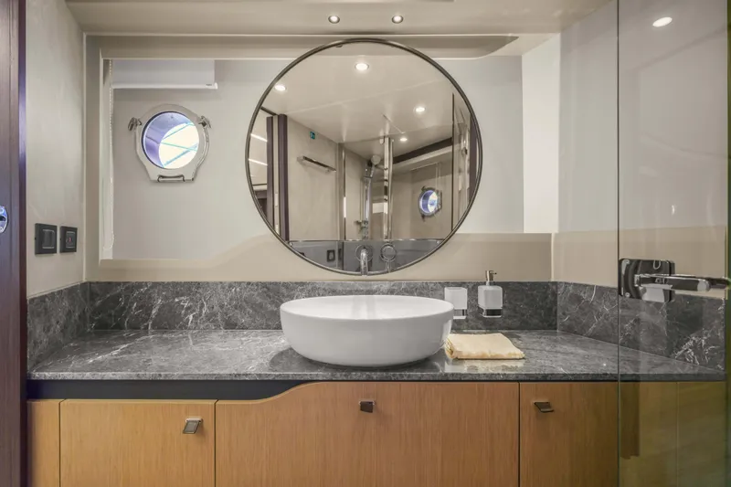 Slide: The Image of Luxurious bathroom on 2026 Absolute 52 Fly yacht with modern sink and round mirror. - 61