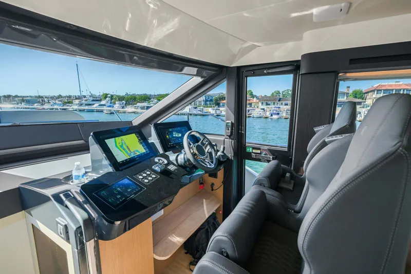 Slide: The Image of Interior view of 2026 Absolute 52 Fly yacht cockpit with modern navigation systems. - 28