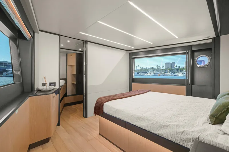 Slide: The Image of Luxurious interior of 2026 Absolute 52 Fly yacht with modern bedroom and scenic window view. - 44