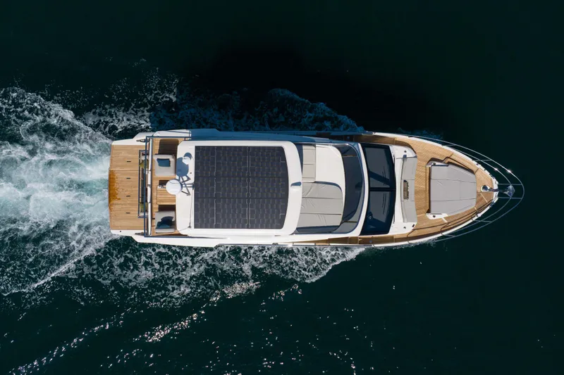 Slide: The Image of Aerial view of 2026 Absolute 52 Fly yacht cruising on open water. - 7
