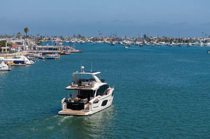 Slide: The Image of Luxury Absolute 52 Fly yacht cruising in a scenic harbor, 2026 model. - 62