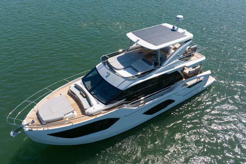 Slide: The Image of Luxury Absolute 52 Fly yacht cruising on open water, 2026 model. - 3