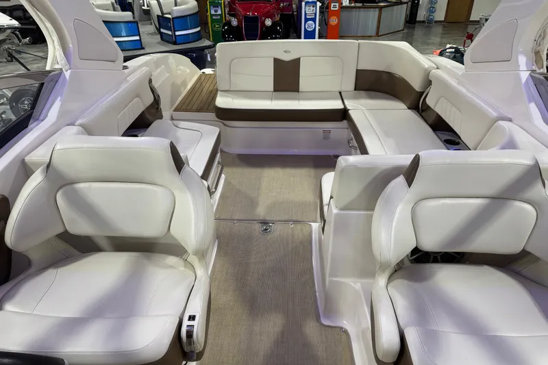 Slide: The Image of Interior of a 2016 Chaparral 307 SSX boat with white and brown seating. - 10
