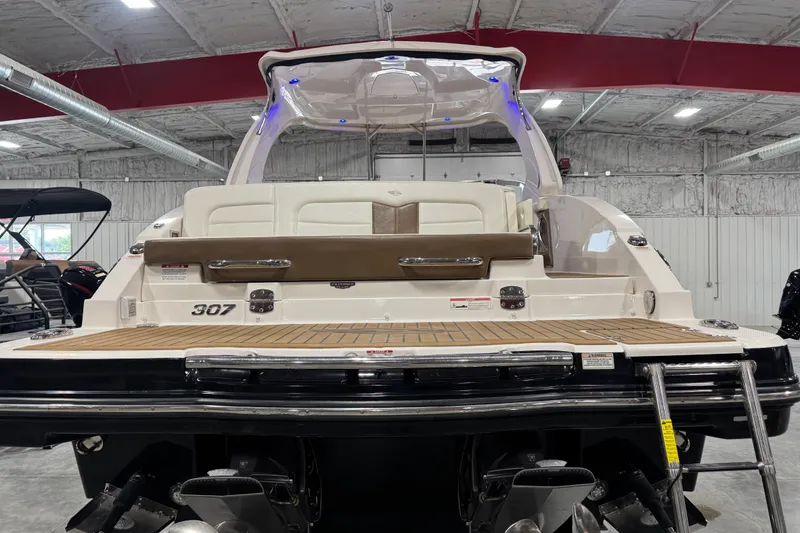 Slide: The Image of 2016 Chaparral 307 SSX boat in showroom, rear view with swim platform and seating. - 5