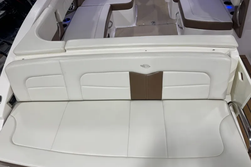 Slide: The Image of 2016 Chaparral 307 SSX boat interior with white and brown seating. - 7