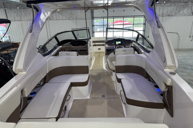 Slide: The Image of Interior view of a 2016 Chaparral 307 SSX boat with luxurious seating and modern dashboard. - 6