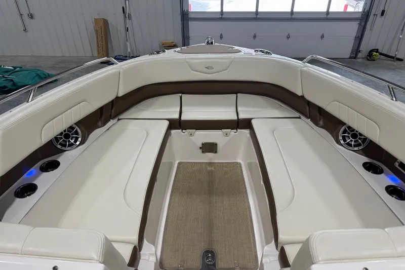 Slide: The Image of 2016 Chaparral 307 SSX boat interior with white seating and cup holders. - 14