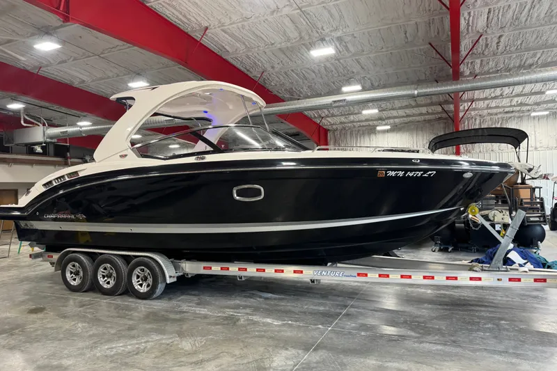The Image of 2016 Chaparral 307 SSX boat on trailer in indoor storage facility. - 1