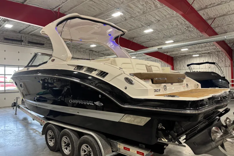 Slide: The Image of 2016 Chaparral 307 SSX boat in a showroom, showcasing sleek design and luxury features. - 3