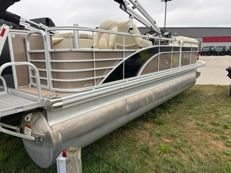 The Image of A 2014 Bennington 2075 GS pontoon boat on grass. It features beige seating. - 1
