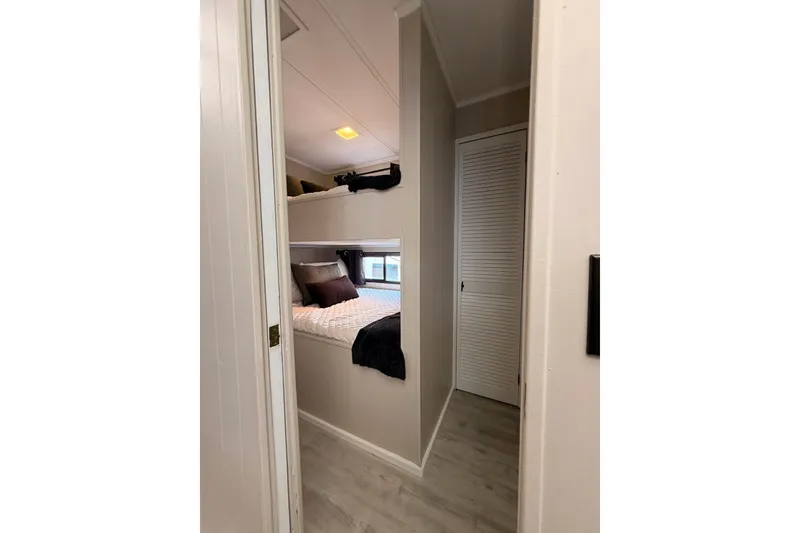 Slide: The Image of Interior of 1991 Leisure Time 14x63 mobile home with cozy bunk beds and modern decor. - 26