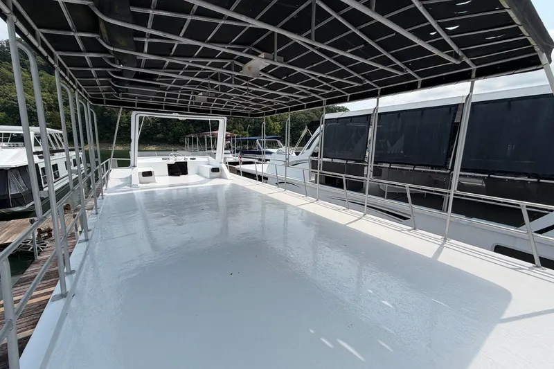 Slide: The Image of Spacious deck of 1991 Leisure Time 14x63 houseboat with canopy and railing. - 4