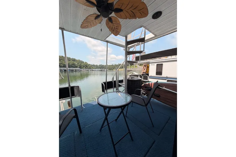 Slide: The Image of Houseboat deck with chairs and table overlooking serene lake, Leisure Time 14x63, 1991 model. - 40