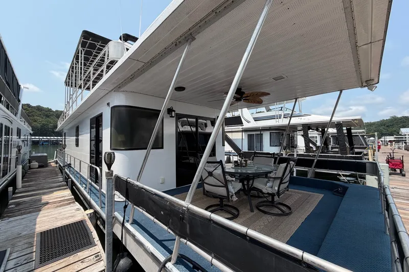 Slide: The Image of Houseboat docked with outdoor seating, Leisure Time 14x63 model, 1991. - 48