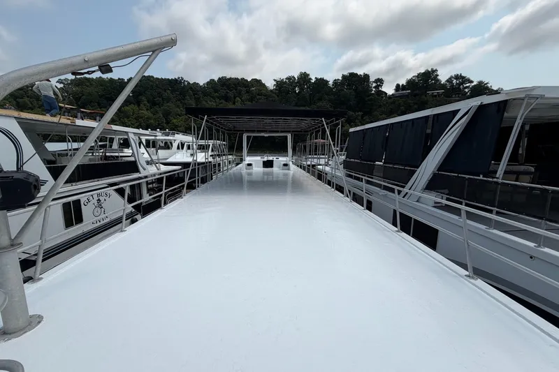 Slide: The Image of Top deck view of a 1991 Leisure Time 14x63 houseboat docked at a marina. - 7