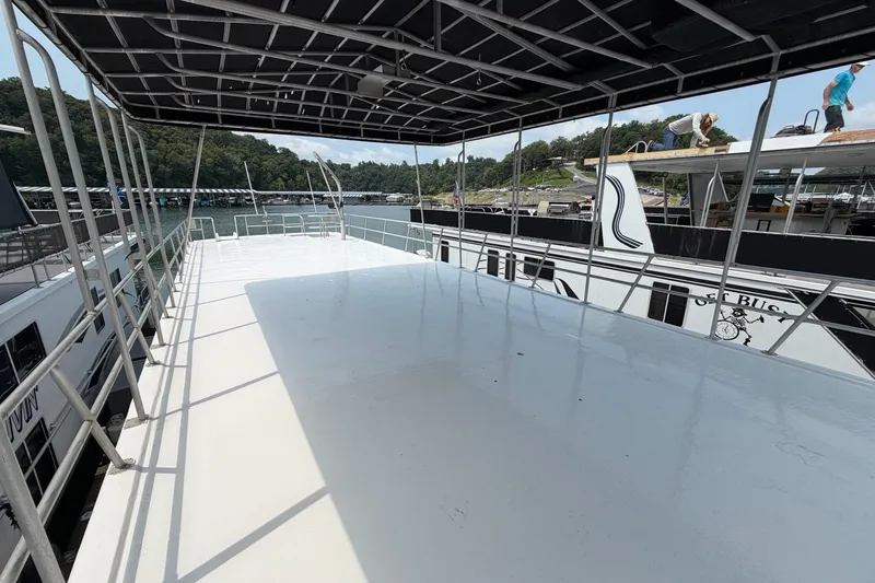 Slide: The Image of Upper deck of a 1991 Leisure Time 14x63 houseboat, docked by a scenic lakeside. - 3