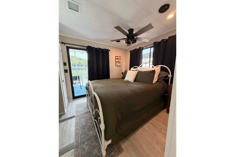 Slide: The Image of Cozy bedroom in 1991 Leisure Time 14x63 houseboat with lake view and elegant decor. - 35