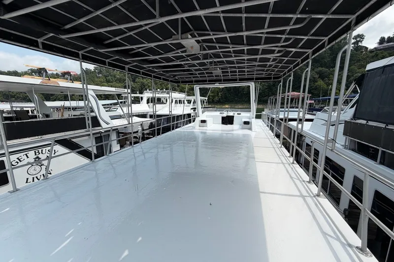Slide: The Image of Spacious deck of a 1991 Leisure Time 14x63 houseboat, docked at a marina. - 5