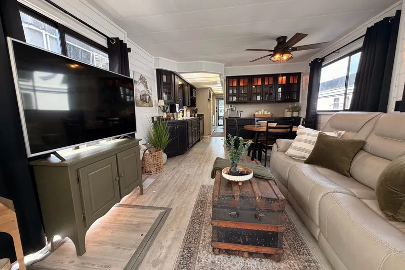 Slide: The Image of Modern 1991 Leisure Time 14x63 interior with cozy living area, stylish decor, and large TV. - 18