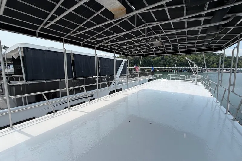 Slide: The Image of Rooftop deck of 1991 Leisure Time 14x63 houseboat with canopy, docked by the lake. - 2