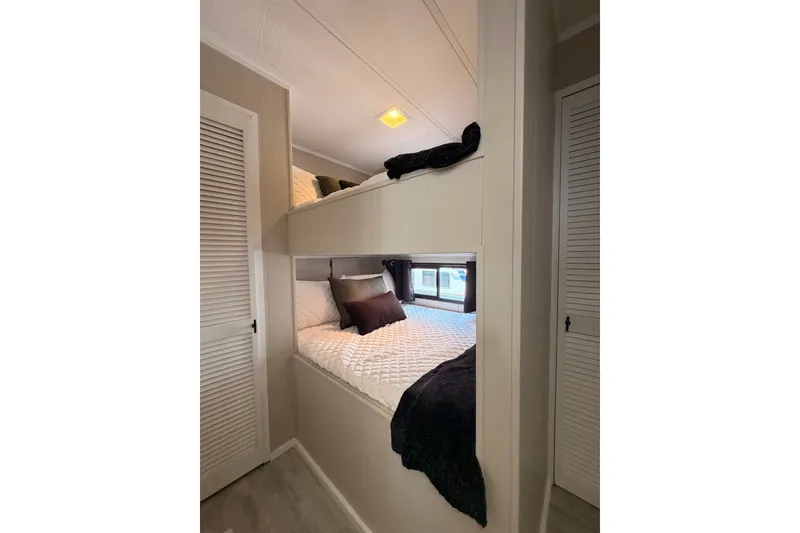 Slide: The Image of Bunk beds in a 1991 Leisure Time 14x63 mobile home, featuring cozy bedding and modern decor. - 27