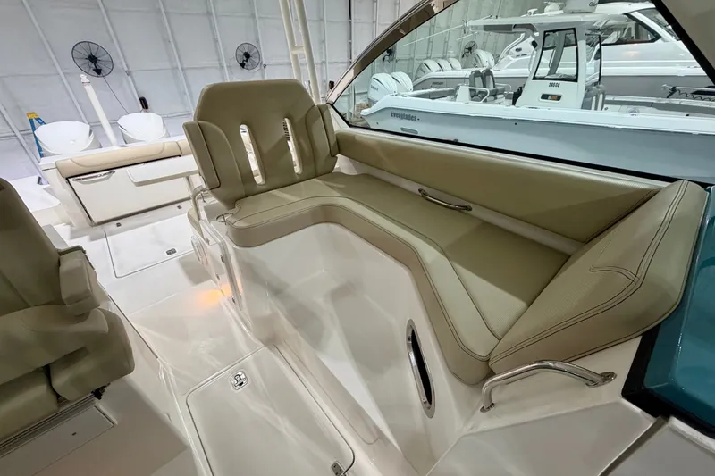 Slide: The Image of 2019 Pursuit DC 325 Dual Console interior with beige seating and sleek design. - 21