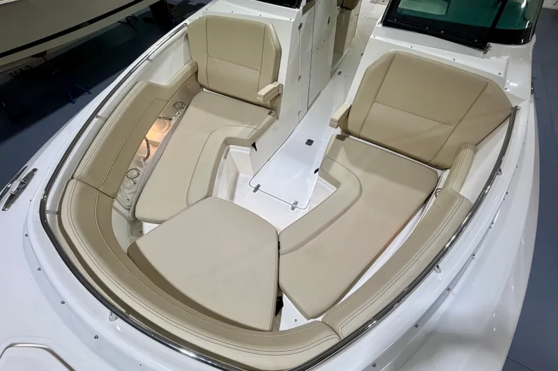 Slide: The Image of 2019 Pursuit DC 325 Dual Console boat with beige seating in the bow area. - 25