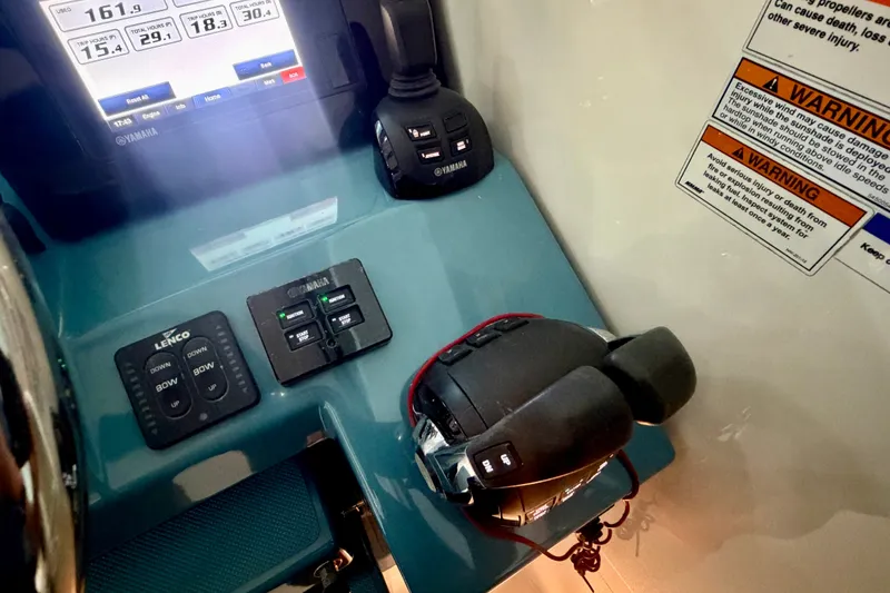 Slide: The Image of Control panel of 2019 Pursuit DC 325 Dual Console boat with Yamaha controls and warning labels. - 15