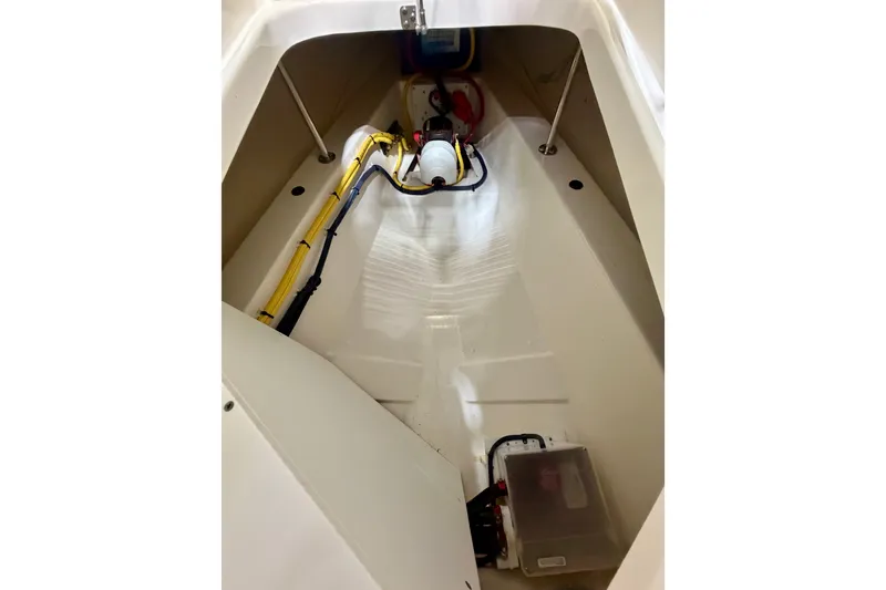 Slide: The Image of 2019 Pursuit DC 325 Dual Console interior compartment with wiring and equipment. - 40