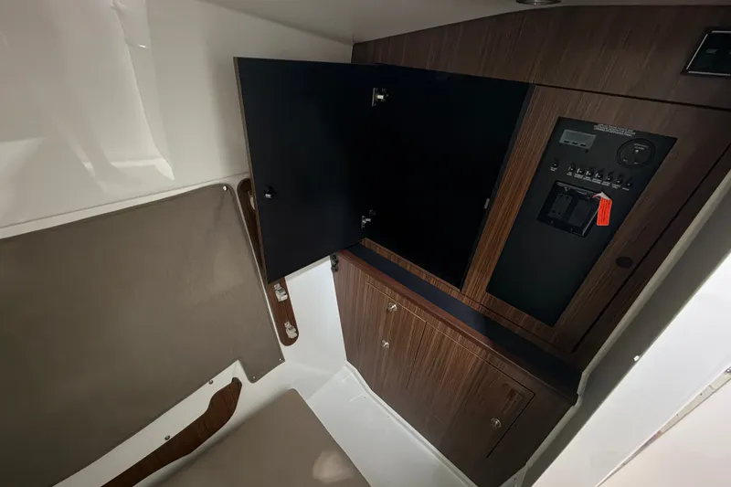 Slide: The Image of 2019 Pursuit DC 325 Dual Console interior with wood paneling and control panel. - 35