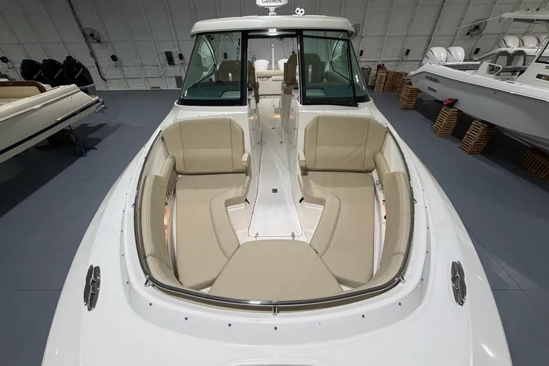 Slide: The Image of 2019 Pursuit DC 325 Dual Console boat with spacious seating in a showroom. - 23