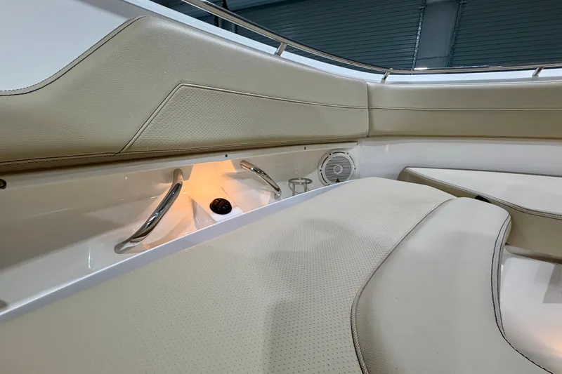 Slide: The Image of 2019 Pursuit DC 325 Dual Console interior with beige seating and ambient lighting. - 27