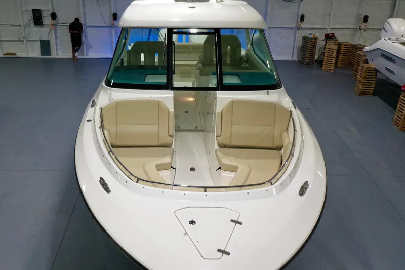 Slide: The Image of 2019 Pursuit DC 325 Dual Console boat with spacious seating in a showroom. - 24
