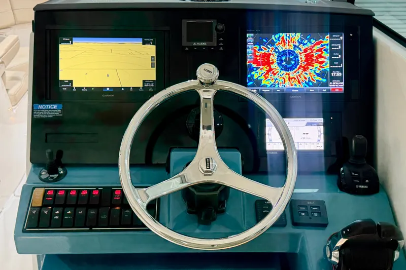 Slide: The Image of Steering console of 2019 Pursuit DC 325 Dual Console with advanced navigation displays. - 14