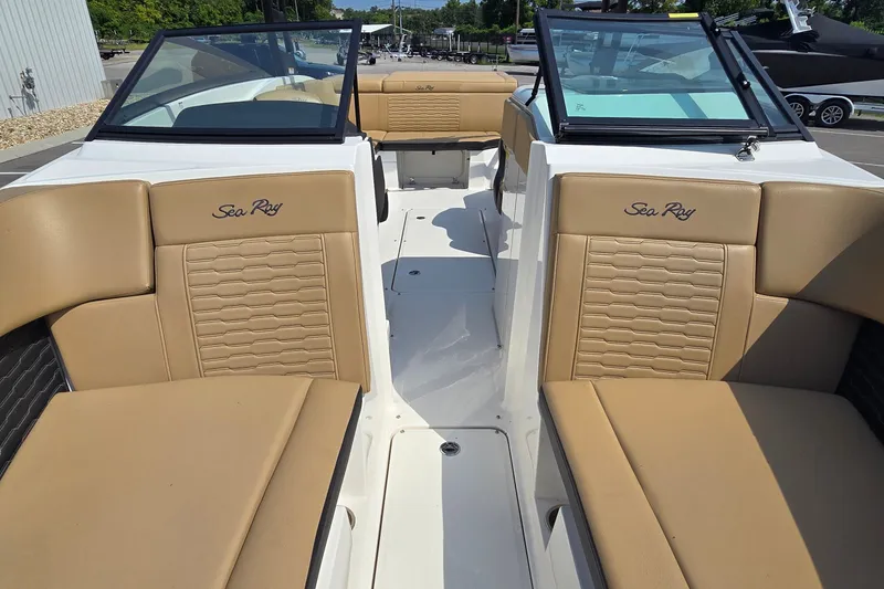 Slide: The Image of 2024 Sea Ray SPX 230 boat interior with tan seating and sleek design. - 7