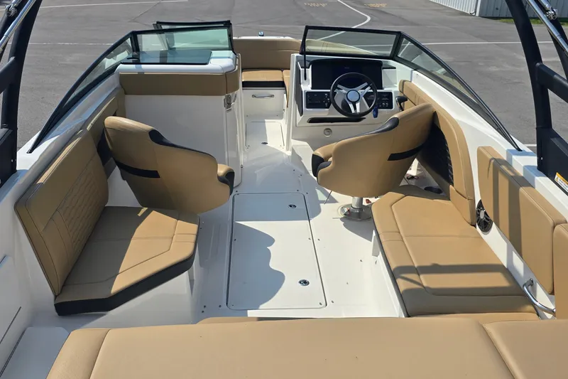 Slide: The Image of 2024 Sea Ray SPX 230 boat interior with tan seating and modern dashboard. - 8