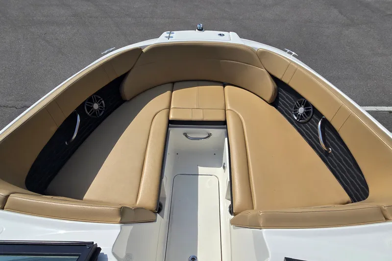 Slide: The Image of 2024 Sea Ray SPX 230 boat interior with tan seating and built-in speakers. - 6