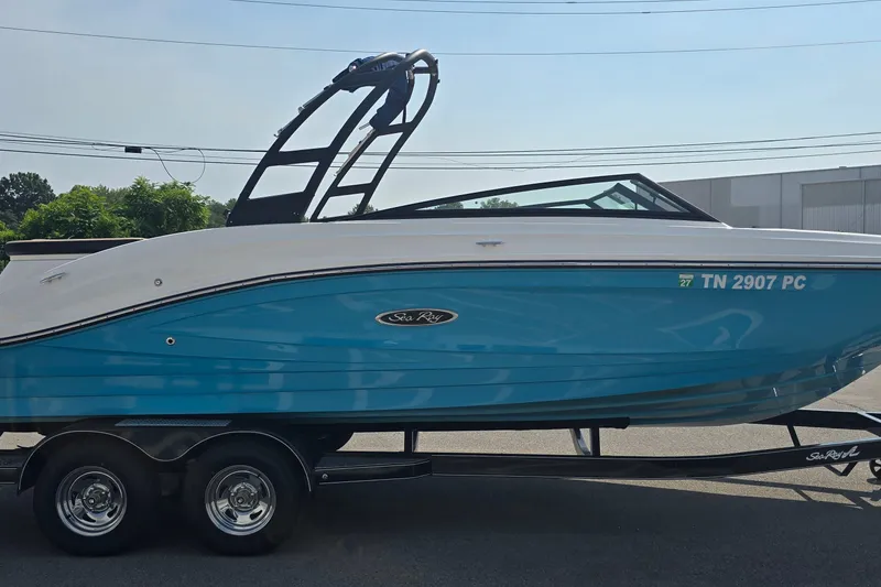 Slide: The Image of 2024 Sea Ray SPX 230 boat on trailer, blue and white design, side view. - 3