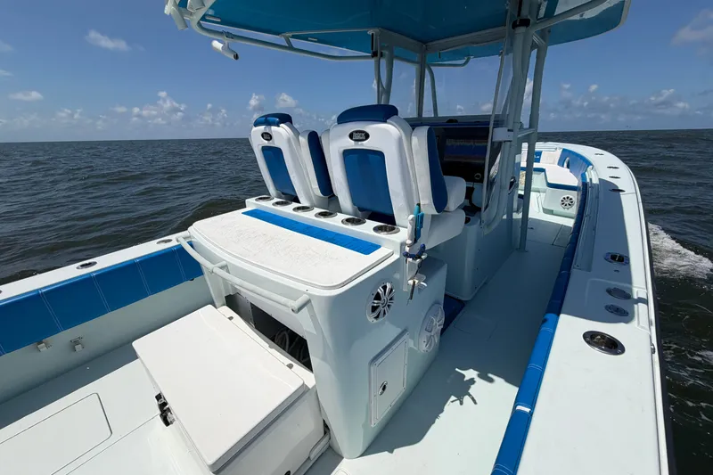 Slide: The Image of 2012 Contender 35 ST boat interior with blue and white seating, on open water. - 27