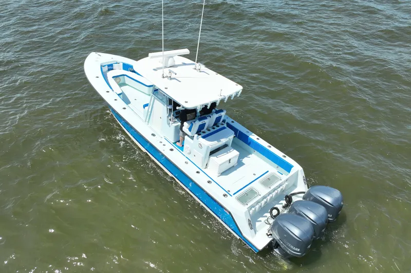 Slide: The Image of 2012 Contender 35 ST boat with triple Yamaha engines on open water. - 12
