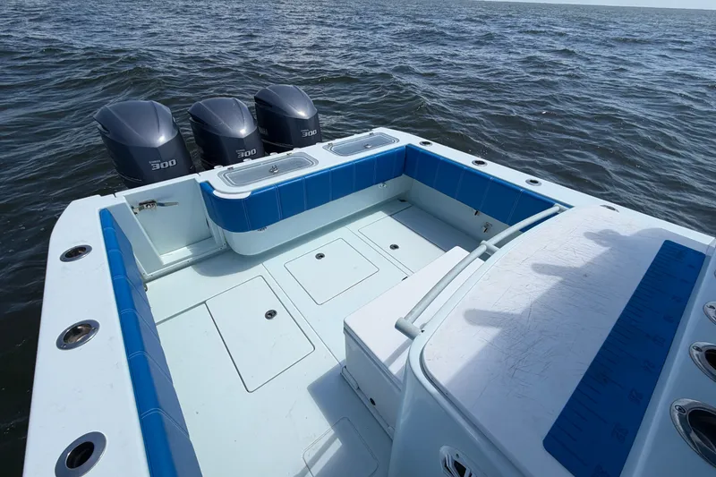 Slide: The Image of 2012 Contender 35 ST boat with triple 300 horsepower engines on open water. - 17